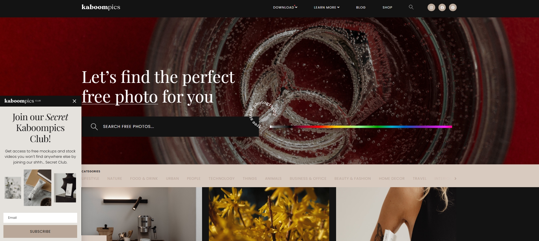 Kaboompics homepage featuring a vibrant drink photo background, a color search slider, and photo category options
