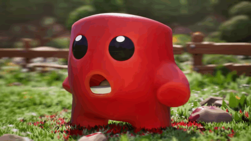 A bright red character with big black eyes stands on grass near a wooden fence in a colorful indie game scene