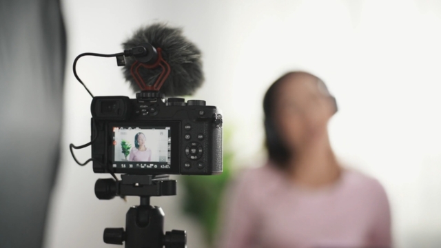 Camera recording a woman with a headset