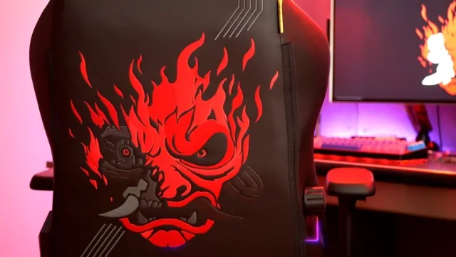 A gaming chair with a bold red flame design sits in a setup that highlights modern room design ideas