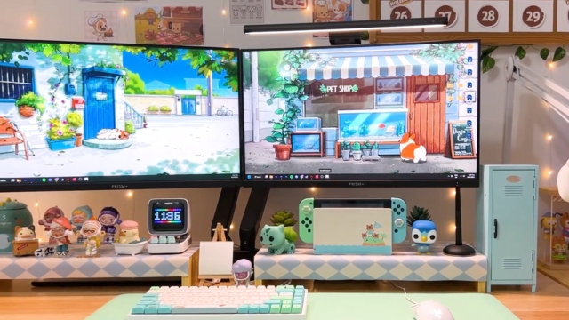 A pastel gaming setup with cute figures and dual monitors creates a cozy Animal Crossing vibe