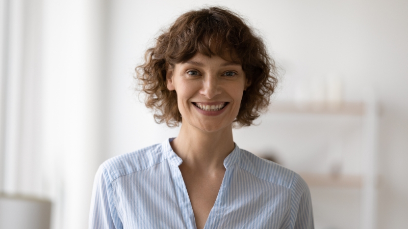 Smiling woman in soft light before professional Photoshop retouching for headshots