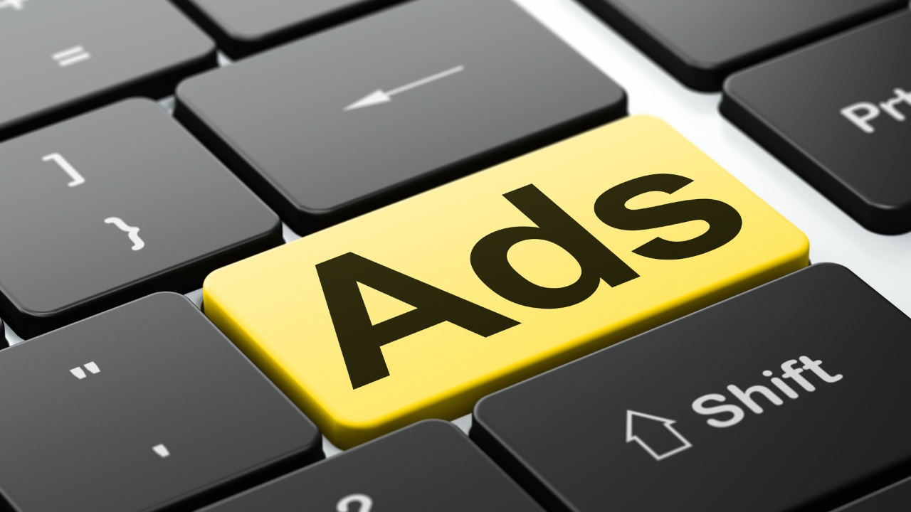 A yellow ads key stands out on a close-up keyboard