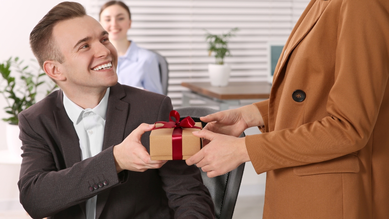 Man receives a corporate gift at an office meeting