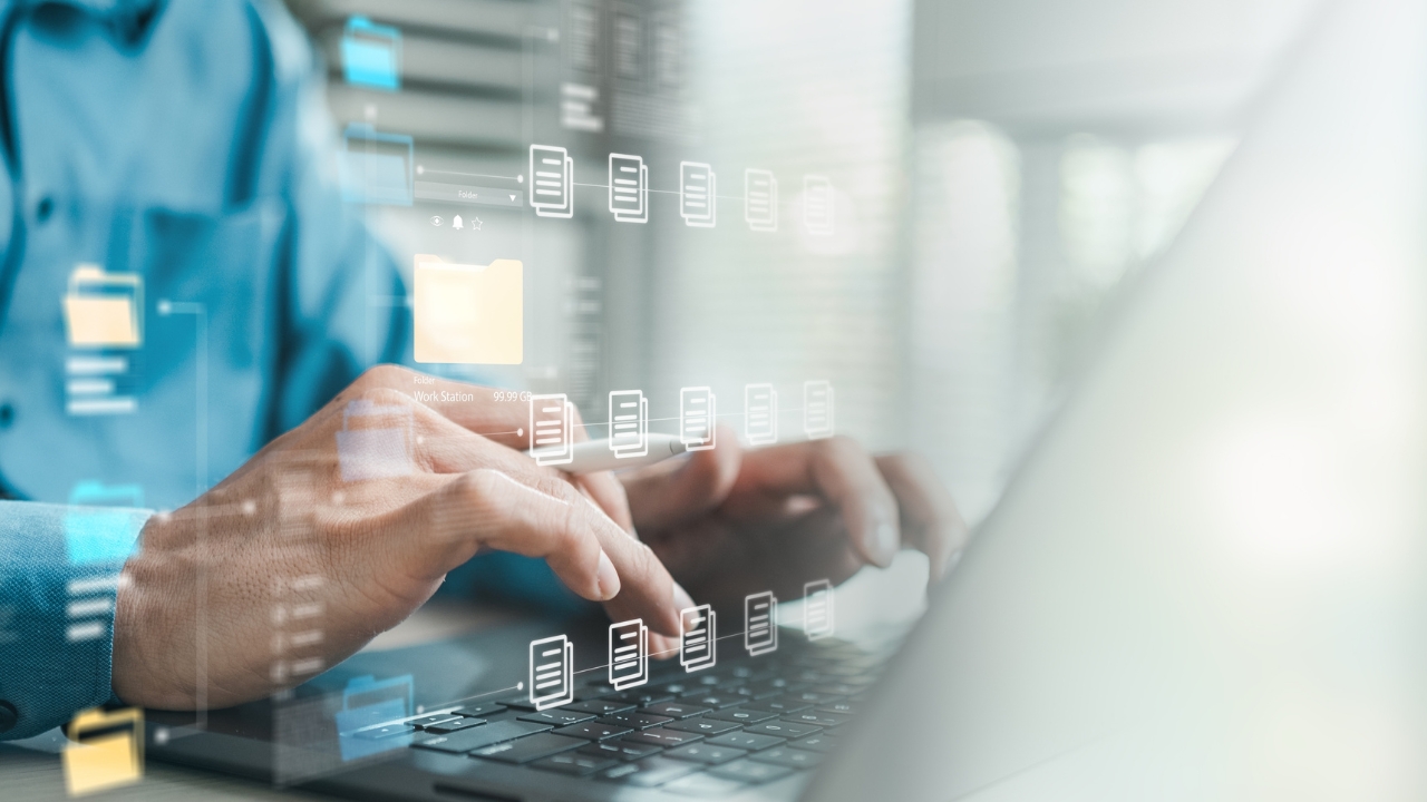A person manages digital files on a laptop