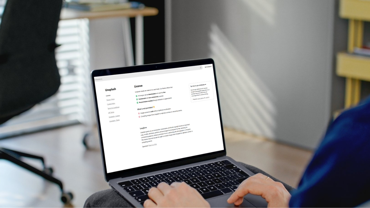 Person checking a stock photo license page on a laptop
