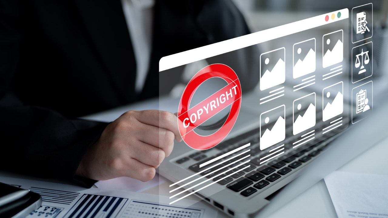 Laptop screen showing a copyright warning over online image files