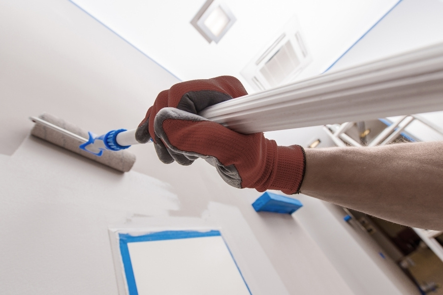 Interior wall being painted with a roller during a home improvement project