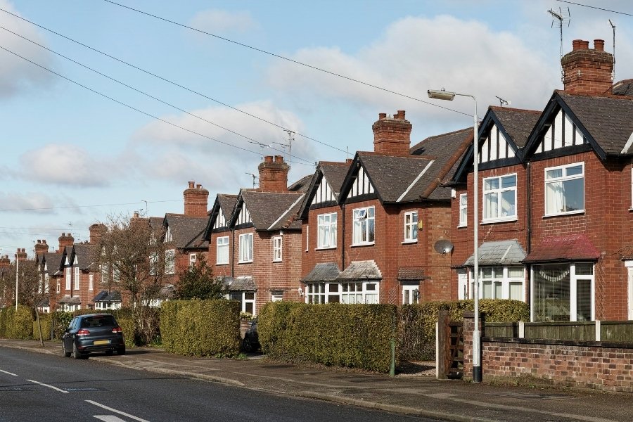 Suburban street with red brick houses in a row. 